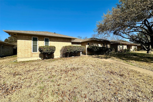 view of property exterior with a lawn