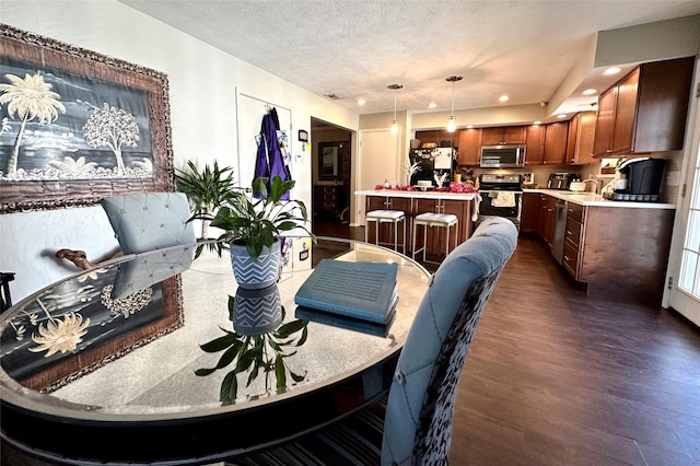 living room with sink, a textured ceiling, and dark hardwood / wood-style flooring