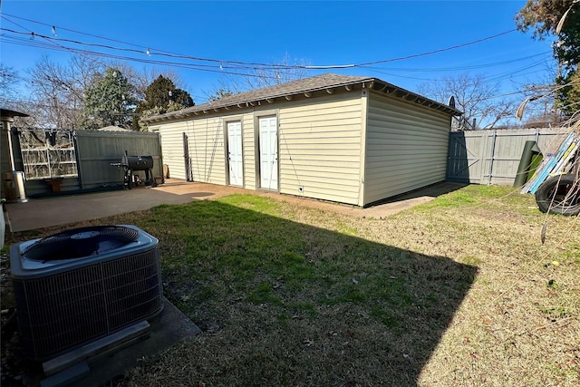 view of outbuilding with a yard and central AC