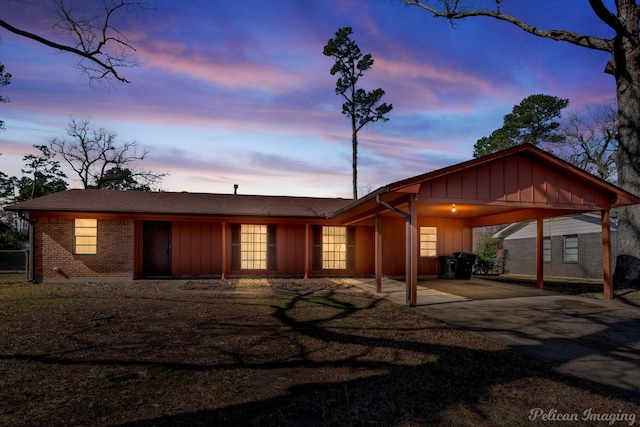 ranch-style home featuring a carport