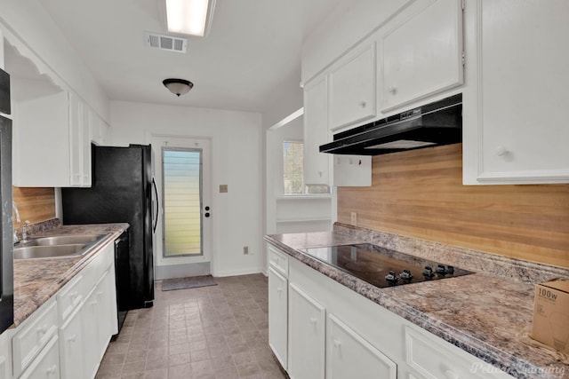 kitchen with tasteful backsplash, sink, white cabinets, and black appliances