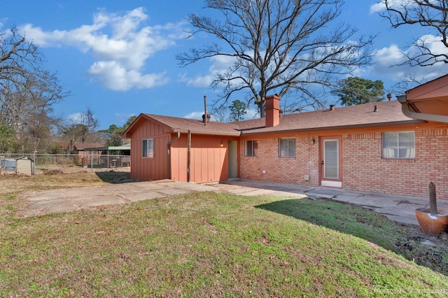 back of property with a patio and a yard