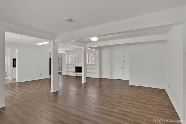 basement with dark hardwood / wood-style flooring