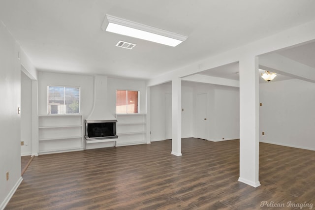 unfurnished living room featuring dark hardwood / wood-style floors