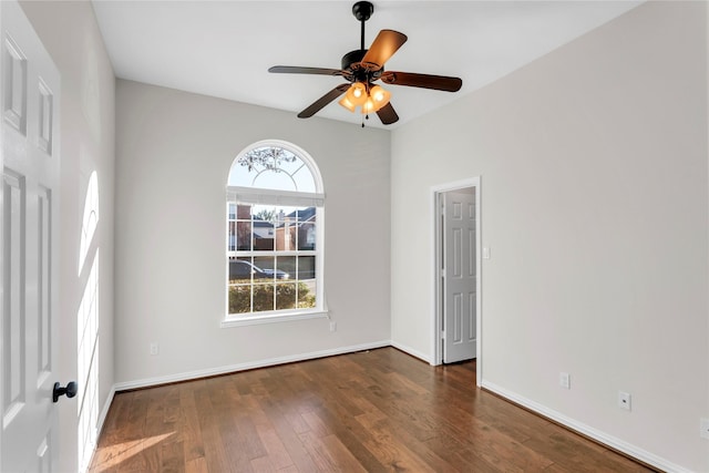 spare room with ceiling fan and dark hardwood / wood-style floors