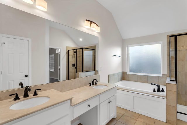 bathroom with tile patterned flooring, shower with separate bathtub, lofted ceiling, and vanity