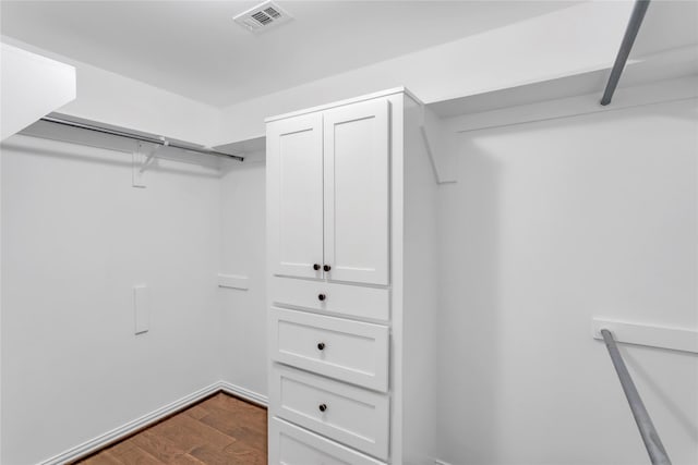 walk in closet with hardwood / wood-style floors