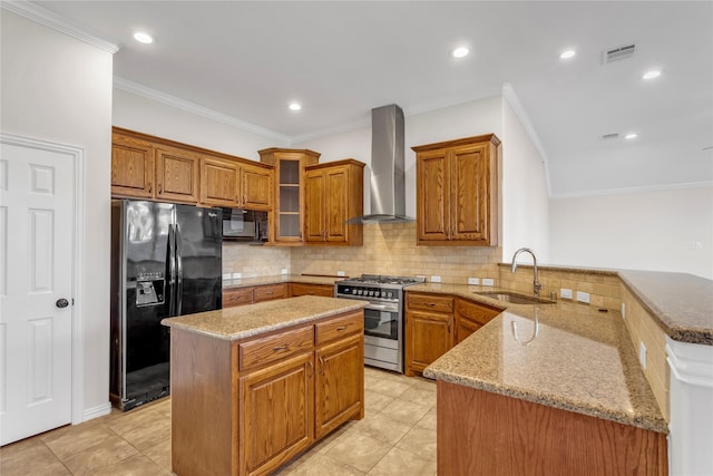 kitchen featuring wall chimney range hood, sink, a center island, black appliances, and kitchen peninsula