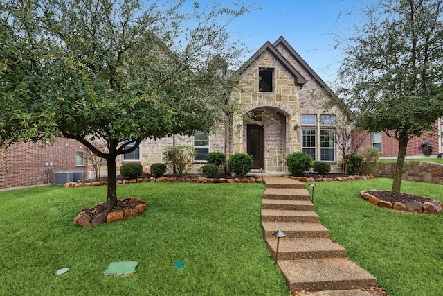 view of front facade with central AC and a front yard