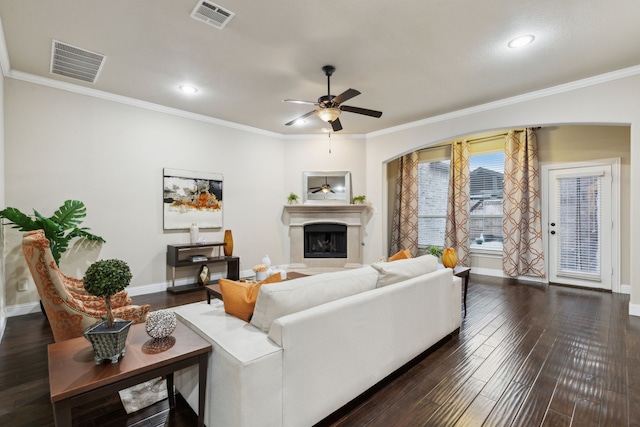 living room with ceiling fan, ornamental molding, and dark hardwood / wood-style flooring