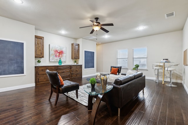 living room featuring ceiling fan and dark hardwood / wood-style flooring