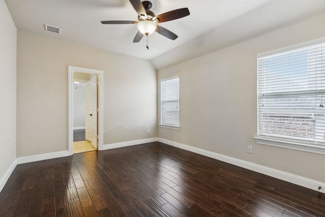 empty room featuring hardwood / wood-style floors, vaulted ceiling, and ceiling fan