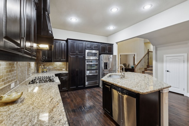 kitchen featuring light stone countertops, appliances with stainless steel finishes, sink, and dark hardwood / wood-style floors