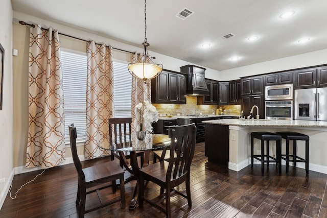 dining space featuring dark hardwood / wood-style flooring and sink