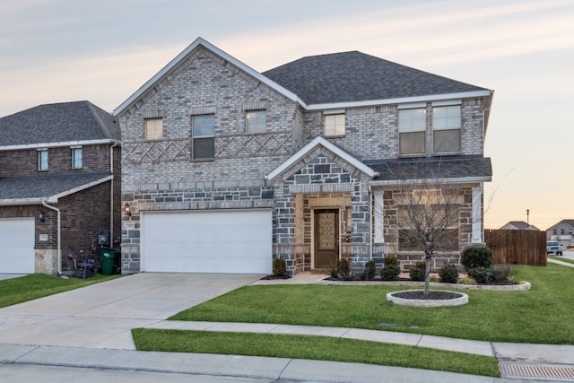 view of front facade with a garage and a lawn