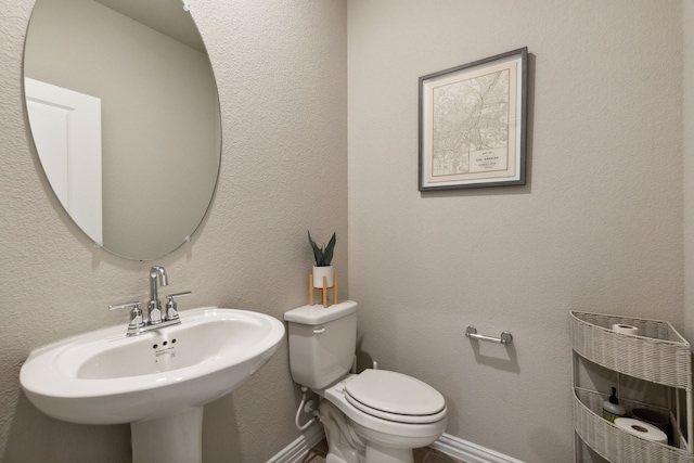 bathroom featuring sink and toilet