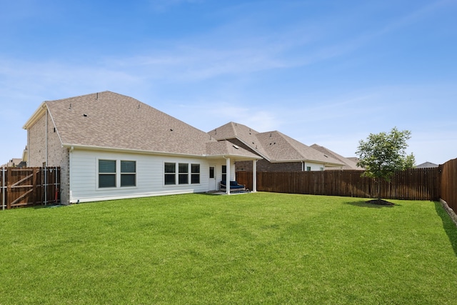 rear view of property with a lawn