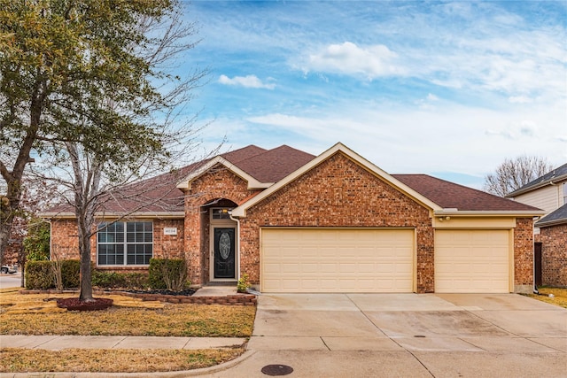 ranch-style house featuring a garage, driveway, brick siding, and roof with shingles