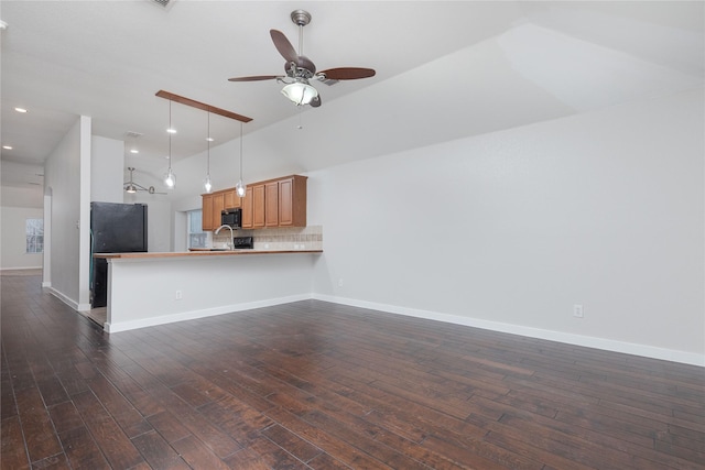 unfurnished living room featuring a ceiling fan, baseboards, and dark wood-type flooring