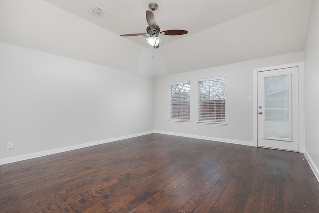 unfurnished room with baseboards, visible vents, lofted ceiling, ceiling fan, and dark wood-type flooring