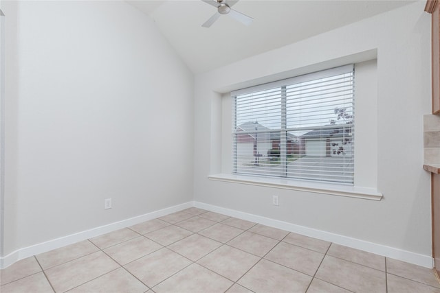 unfurnished room featuring ceiling fan, baseboards, and vaulted ceiling