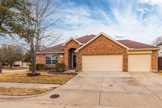 ranch-style house with an attached garage, driveway, a shingled roof, and brick siding