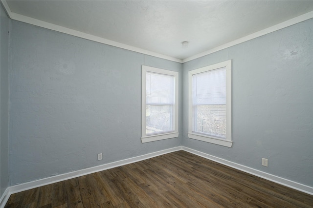 empty room with crown molding and dark wood-type flooring