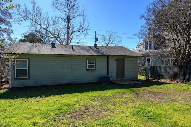 back of house with a yard and cooling unit