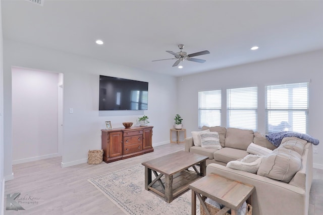 living room with ceiling fan and light hardwood / wood-style floors