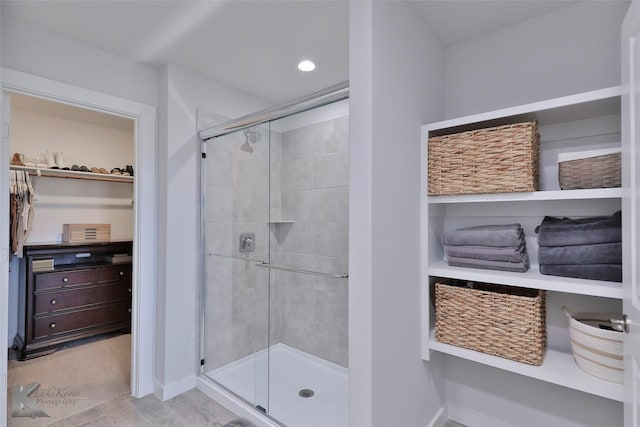 bathroom featuring a shower with shower door