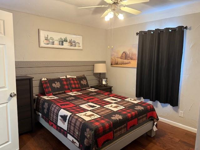 bedroom featuring dark wood-type flooring and ceiling fan