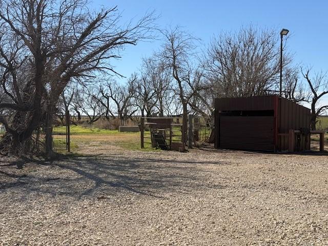 view of yard featuring an outbuilding and a garage