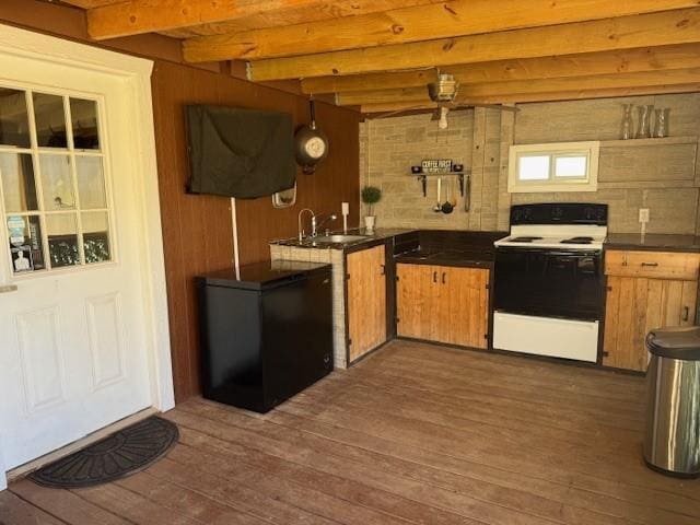 kitchen with fridge, beamed ceiling, dark hardwood / wood-style floors, and white range with electric stovetop