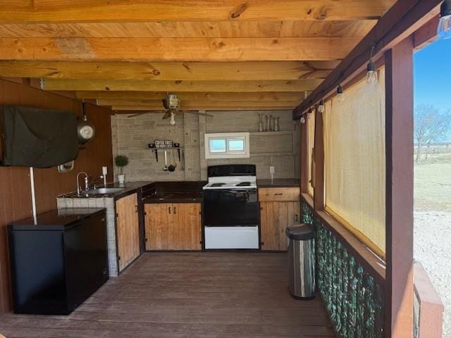 kitchen featuring electric stove, sink, dark hardwood / wood-style flooring, and beamed ceiling