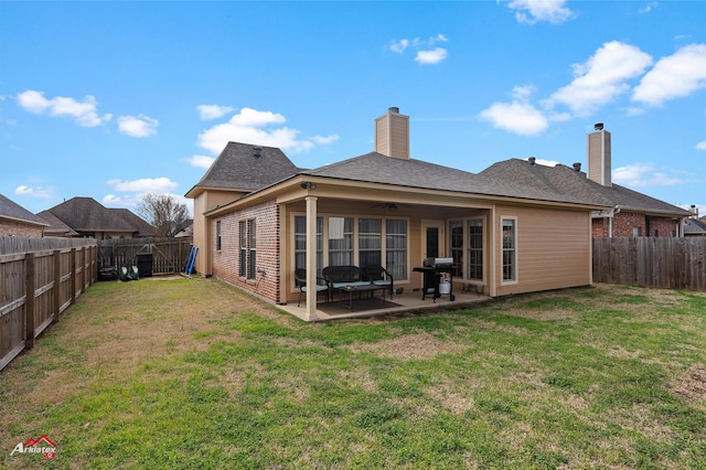 back of house featuring a patio, a yard, and ceiling fan