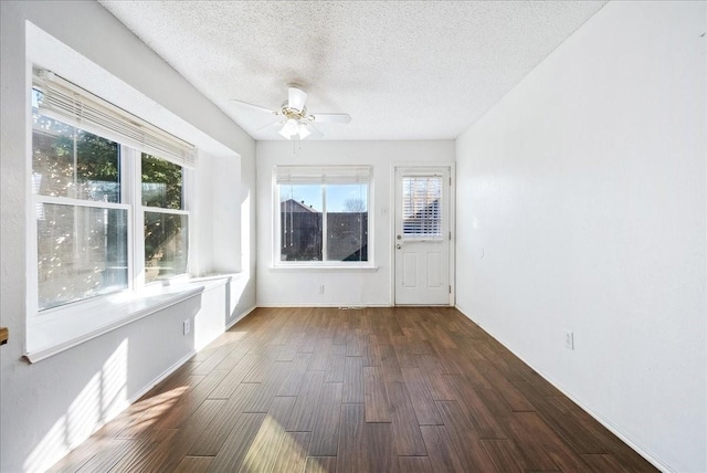 unfurnished sunroom with ceiling fan