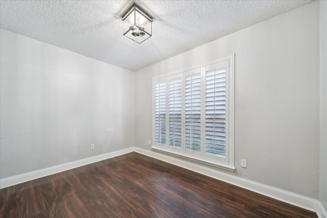 unfurnished room with hardwood / wood-style floors and a textured ceiling