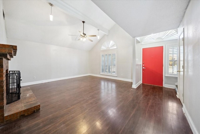 unfurnished living room featuring dark hardwood / wood-style flooring, a brick fireplace, lofted ceiling with beams, and ceiling fan