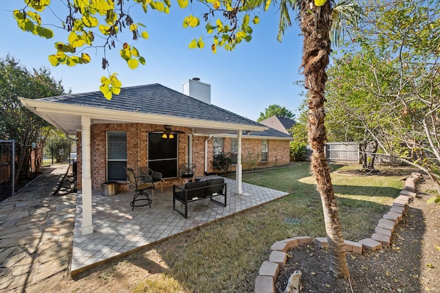 view of yard with ceiling fan, outdoor lounge area, and a patio