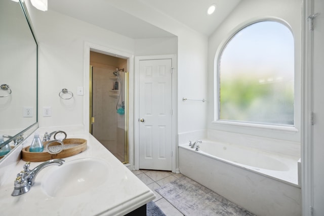 bathroom with tile patterned flooring, vanity, and separate shower and tub