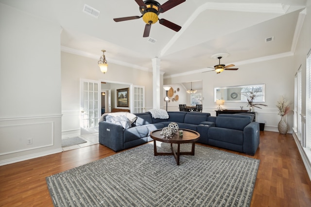 living room featuring ornate columns, high vaulted ceiling, hardwood / wood-style flooring, crown molding, and french doors