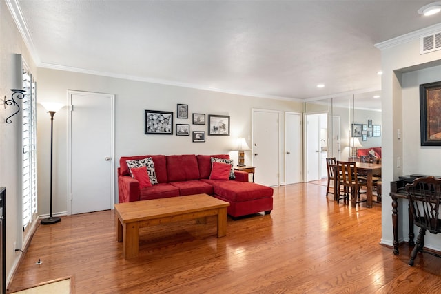 living room featuring ornamental molding and light hardwood / wood-style floors