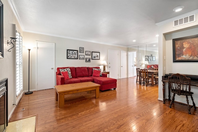 living room featuring wood-type flooring and ornamental molding