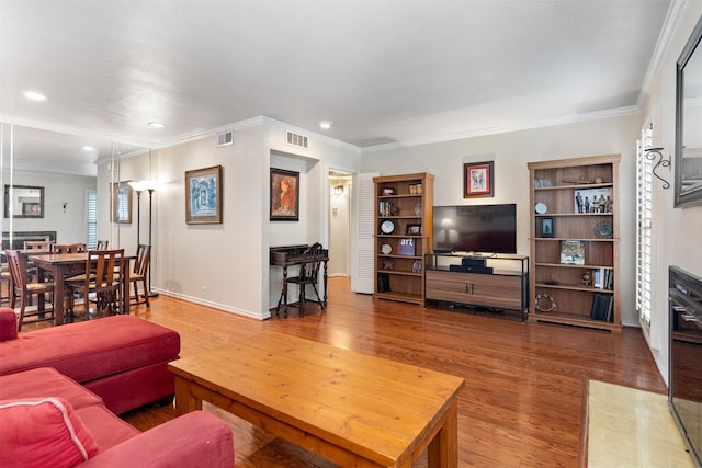 living room featuring hardwood / wood-style flooring and crown molding