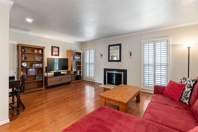 living room featuring hardwood / wood-style flooring and ornamental molding