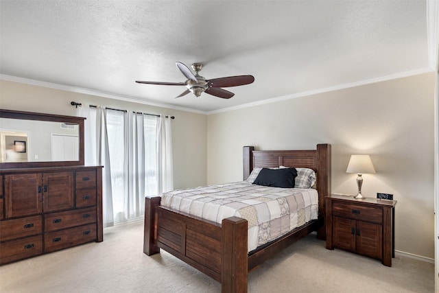 bedroom featuring crown molding, ceiling fan, light carpet, and a textured ceiling