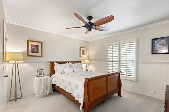 carpeted bedroom featuring ornamental molding and ceiling fan