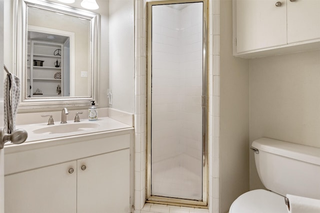 bathroom featuring vanity, toilet, and an enclosed shower