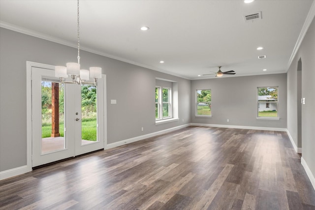 empty room featuring crown molding, dark wood-type flooring, and ceiling fan with notable chandelier