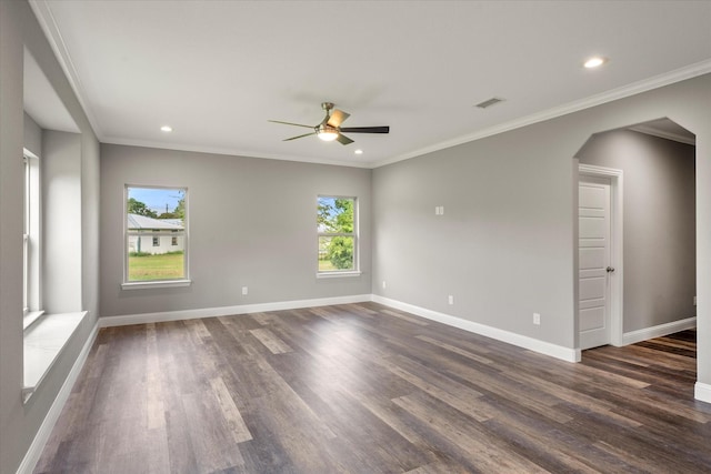 spare room featuring dark hardwood / wood-style flooring, crown molding, and ceiling fan